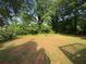 Large backyard with grass and trees, great for entertaining or relaxing at 1231 Providence Way, Lawrenceville, GA 30046
