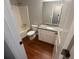 Bathroom featuring white cabinets, granite countertops, shower and tub combination, and wood look floors at 1231 Providence Way, Lawrenceville, GA 30046