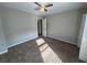 This bedroom features neutral walls, carpeted floors, a ceiling fan, and white doors at 1231 Providence Way, Lawrenceville, GA 30046