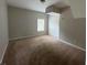Comfortable carpeted bedroom featuring neutral paint and bright window at 1231 Providence Way, Lawrenceville, GA 30046