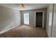 This bedroom features neutral walls, carpeted floors, a ceiling fan, and a closet at 1231 Providence Way, Lawrenceville, GA 30046