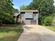 Charming home featuring a yellow front door, attached garage, and a spacious driveway at 1231 Providence Way, Lawrenceville, GA 30046