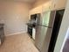 Efficient kitchen featuring stainless steel refrigerator and granite countertops at 1231 Providence Way, Lawrenceville, GA 30046