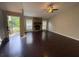 Cozy living room featuring stone fireplace and hardwood floors at 1231 Providence Way, Lawrenceville, GA 30046
