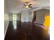 Open-concept living area with hardwood floors and bright yellow door at 1231 Providence Way, Lawrenceville, GA 30046