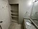 Well-lit bathroom featuring a granite countertop, open shelving, and a white ceramic sink at 2036 Countydown Ln, Stone Mountain, GA 30088
