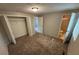 Neutral bedroom features closet, ensuite bathroom, and plush carpet at 2036 Countydown Ln, Stone Mountain, GA 30088