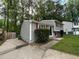Charming two-story home with gray siding and red shutters in a wooded setting at 2036 Countydown Ln, Stone Mountain, GA 30088
