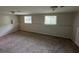 Large living room with plush carpeting, natural light, and a neutral color palette at 2036 Countydown Ln, Stone Mountain, GA 30088