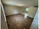 A wide shot of an airy living room with wood floors, neutral walls, and natural light at 2036 Countydown Ln, Stone Mountain, GA 30088