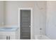 Bathroom with gray door, white countertop, and tiled shower/tub combination at 37 Deer Canyon Dr, Auburn, GA 30011
