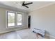 Bedroom showcasing large windows, ceiling fan and boxes of flooring at 37 Deer Canyon Dr, Auburn, GA 30011