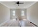 Bright bedroom with a ceiling fan, two windows, and neutral wall color scheme at 37 Deer Canyon Dr, Auburn, GA 30011