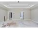 Bedroom showcasing a tray ceiling, neutral walls, and doorways to other rooms at 37 Deer Canyon Dr, Auburn, GA 30011