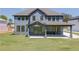 Rear exterior view of the two-story home featuring a covered patio and ample yard space at 37 Deer Canyon Dr, Auburn, GA 30011