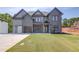 Stunning new construction home featuring a modern design, two-car garage, and manicured lawn at 37 Deer Canyon Dr, Auburn, GA 30011