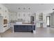 Modern kitchen with a dark island, white cabinetry, and stainless steel finishes, perfect for cooking at 37 Deer Canyon Dr, Auburn, GA 30011