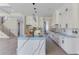 Spacious kitchen with white cabinets, granite countertops, and stainless steel appliances, ideal for cooking and entertaining at 37 Deer Canyon Dr, Auburn, GA 30011