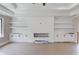 Living room boasts a modern fireplace with built-in cabinets and shelves for decor and storage at 37 Deer Canyon Dr, Auburn, GA 30011