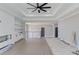 Open-concept living room with fireplace, modern fan, and stairway access at 37 Deer Canyon Dr, Auburn, GA 30011