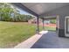 Covered porch with concrete flooring, gray columns and a grassy backyard at 37 Deer Canyon Dr, Auburn, GA 30011