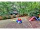 Spacious backyard features playset and lush green grass, perfect for outdoor Gathering fun at 5574 Wynhall Dr, Peachtree Corners, GA 30071