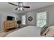 Comfortable bedroom featuring carpet floors, natural lighting, a wooden dresser, and a ceiling fan at 5574 Wynhall Dr, Peachtree Corners, GA 30071
