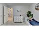 Cozy bedroom featuring plush carpeting, neutral paint, a white dresser, and a decorative plant for a comforting space at 5574 Wynhall Dr, Peachtree Corners, GA 30071