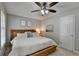 Inviting bedroom with neutral walls, a ceiling fan, and natural light creating a relaxing and peaceful atmosphere at 5574 Wynhall Dr, Peachtree Corners, GA 30071