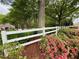 White fencing and colorful flora adorn this community at 5574 Wynhall Dr, Peachtree Corners, GA 30071
