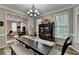 Dining room with a large dark wood table, view to the living room and many windows for natural light at 5574 Wynhall Dr, Peachtree Corners, GA 30071