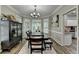 Formal dining room features dark wood furniture, a bay window and views into the kitchen at 5574 Wynhall Dr, Peachtree Corners, GA 30071