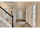 Bright foyer features a staircase, wood-look floors, and a view of the front door at 5574 Wynhall Dr, Peachtree Corners, GA 30071