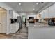 Bright eat-in kitchen boasts white cabinets, stainless steel appliances, and granite countertops at 5574 Wynhall Dr, Peachtree Corners, GA 30071