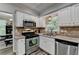 Kitchen with stainless steel appliances, granite countertops, and a view to the formal dining area at 5574 Wynhall Dr, Peachtree Corners, GA 30071