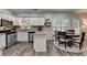 Eat-in kitchen features white cabinets, stainless steel appliances, granite countertops, and a view to the breakfast nook at 5574 Wynhall Dr, Peachtree Corners, GA 30071