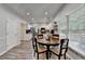 Bright eat-in kitchen features white cabinets, stainless appliances and a round wood table and chairs for casual dining at 5574 Wynhall Dr, Peachtree Corners, GA 30071