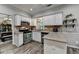 Eat-in kitchen features white cabinets, stainless steel appliances, and granite countertops at 5574 Wynhall Dr, Peachtree Corners, GA 30071