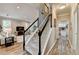 Inviting living room showcasing neutral tones, staircase, and view into the kitchen at 5574 Wynhall Dr, Peachtree Corners, GA 30071