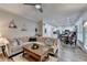 An open-concept living room flows into a breakfast nook and kitchen area, complemented by wood floors and natural light at 5574 Wynhall Dr, Peachtree Corners, GA 30071