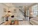 Open-concept living room with staircase, abundant natural light, and cozy seating arrangement at 5574 Wynhall Dr, Peachtree Corners, GA 30071
