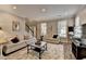 Bright living room features neutral colors, recessed lighting, large windows and a staircase to the second floor at 5574 Wynhall Dr, Peachtree Corners, GA 30071