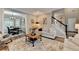 Spacious living room showcases stylish furniture, a neutral color palette, and adjacent dining area at 5574 Wynhall Dr, Peachtree Corners, GA 30071