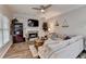 Cozy living room features a decorative fireplace, built-in shelving, ceiling fan and large windows for plenty of natural light at 5574 Wynhall Dr, Peachtree Corners, GA 30071