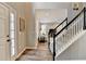 Open living room with staircase, wood-look floors, and view of the formal dining room at 5574 Wynhall Dr, Peachtree Corners, GA 30071