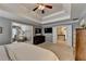 Spacious main bedroom with large bed, tray ceiling, and ensuite entry at 5574 Wynhall Dr, Peachtree Corners, GA 30071