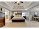 Large main bedroom with tray ceilings, ceiling fan, neutral decor and an ensuite bathroom at 5574 Wynhall Dr, Peachtree Corners, GA 30071