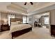 Spacious main bedroom with large bed, ensuite office, tray ceiling, and neutral decor at 5574 Wynhall Dr, Peachtree Corners, GA 30071
