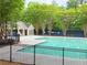Community pool featuring a bath house and iron gate at 5574 Wynhall Dr, Peachtree Corners, GA 30071