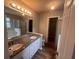 Bathroom features a double vanity, walk-in shower, and tub surrounded by white tiles at 5769 Shadow Creek Dr, Lithonia, GA 30058